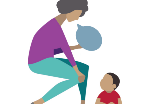 This image shows a mother speaking to her toddler sitting on the floor.
