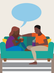 This image shows a couple sitting on a couch with coffee talking.